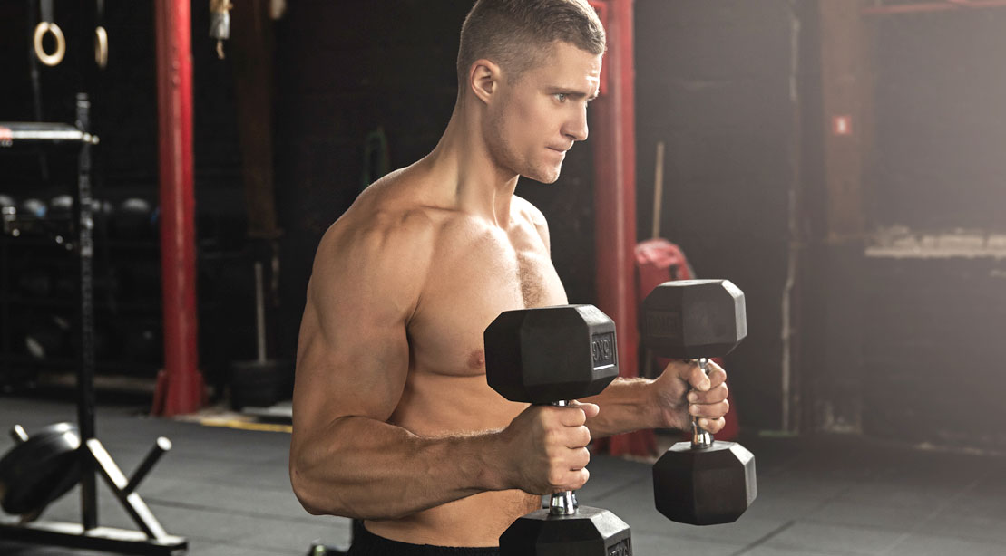 Muscular man doing arm exercises with a hammer curl