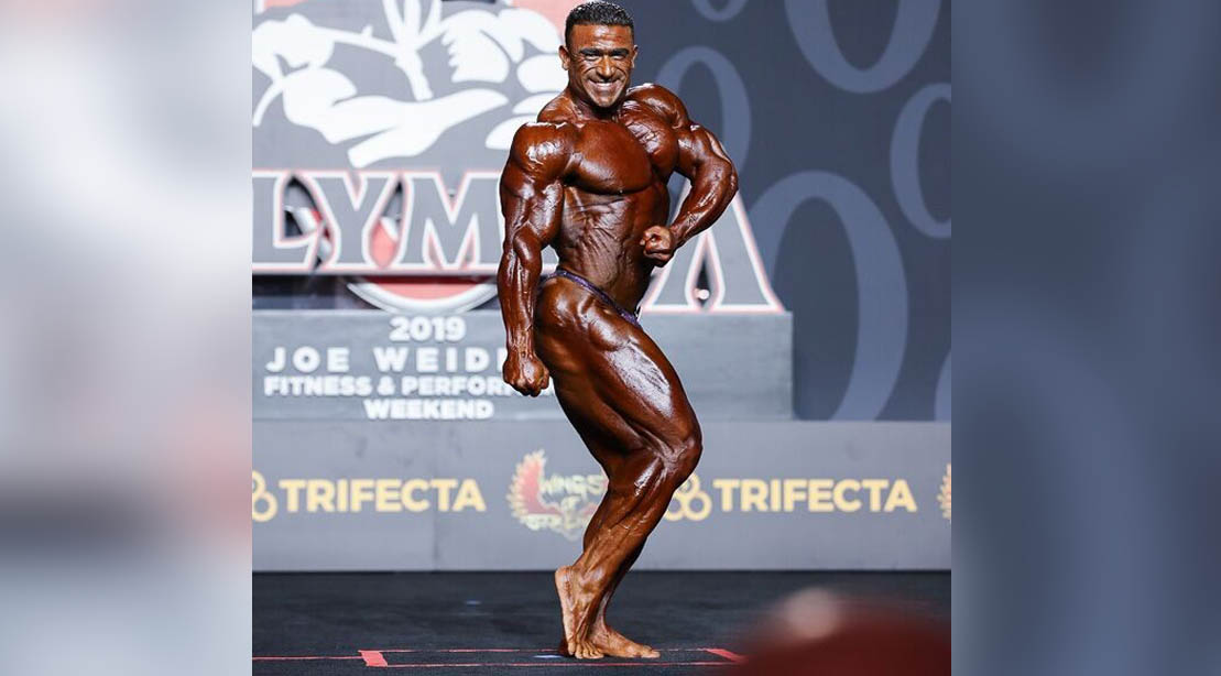 Bodybuilder Kamal Elgargni Posing On Stage At The Mr. Olympia Bodybuilding Competition
