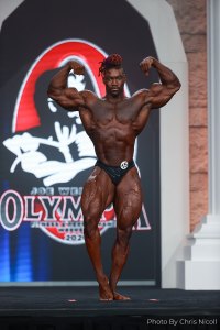 Bryan Jones classic physique bodybuilder posing on stage at the Olympia 2020 Event