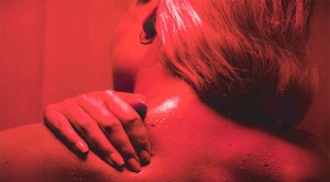 Female using red light therapy to recover from a workout