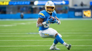 Pro Football Player Austin Ekeler and running back for the NFL Los Angeles Chargers running with a football