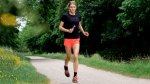 Triathlete Beth Potter running on a path and training for a triathlon using her running tips