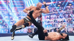 WWE wrestler ‘Swiss Cyborg’ Cesaro performing a elbow drop on pro wrestler Roman Reigns