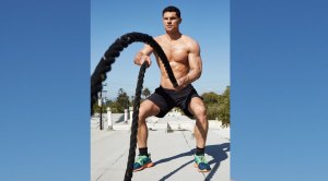 Flula Borg of Suicide Squad working out with battle ropes