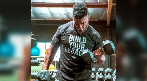 NFL Football Player and founder of Lights Out Fighting Shawne Merriman performing dumbbell bicep curls