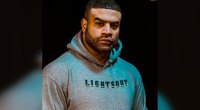 NFL Football Player and founder of Lights Out Fighting Shawne Merriman wearing a grey lights out hoodie