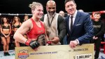 Professional MMA fighter of the Professional Fighter League Kayla Harrison recieving a check from Mike Tyson and the PFL president
