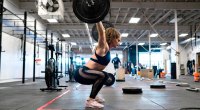 Crossfitter Kelly Stone training in the gym with a barbell clean jerk and snatch olympic lift