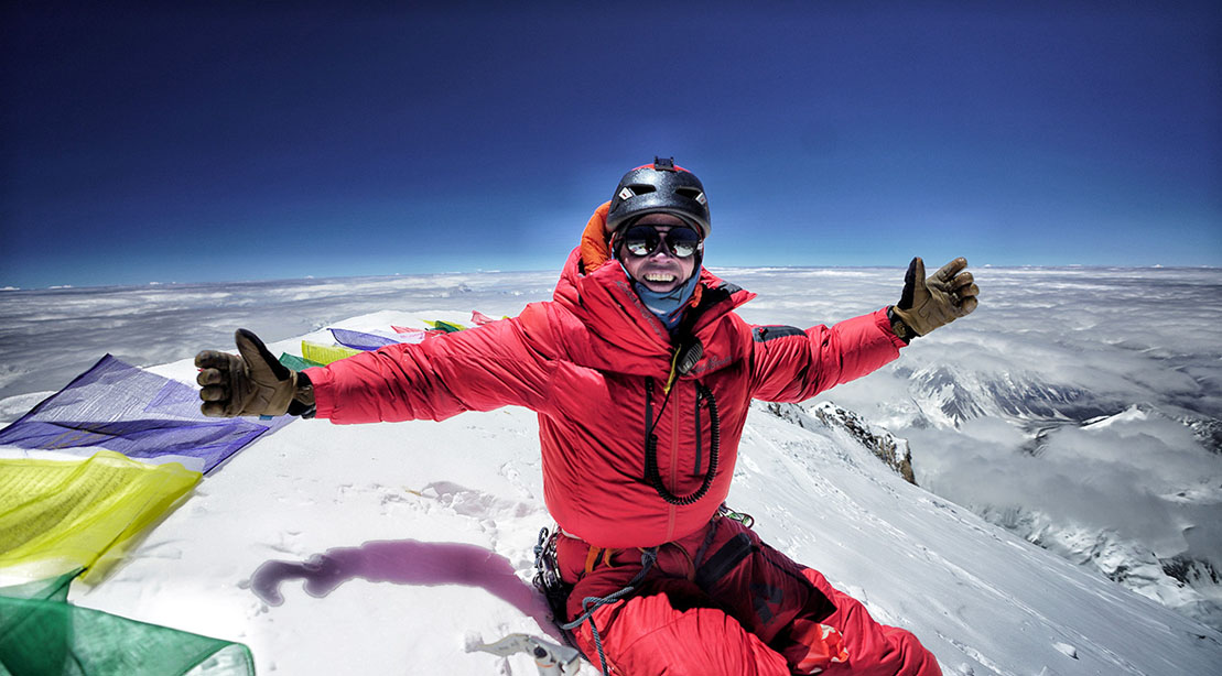 Climber Adrian Ballinger climbing the summit of a mountain range