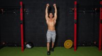 Don Saladino performing a kettlebell press in the gym