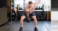 Erik Bartell performing a One-Arm Kettlebell Swing exercise for his Athletic Soldier Full-Body Workout Routine