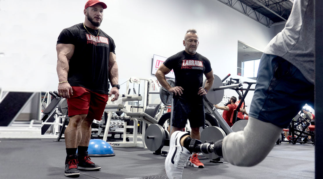 Father and son bodybuilders Hunter Labrada and Lee Labrada training with a military veteran at Team RWB