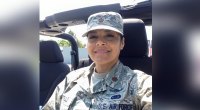 Katherine Portillo in her army uniform driving in a jeep