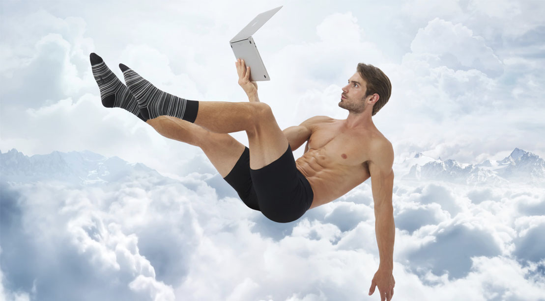 Muscular man wearing jetsetter boxer briefs and floating on clouds