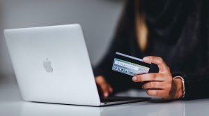 Female using a credit card and a macbook to do some online shopping