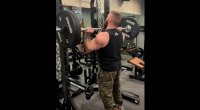 Jordan Shallow performing a standing barbell press for his shoulder training day with Frank Sepe and Don Saladino