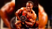 Lee Haney trains with a barbell concentration curl