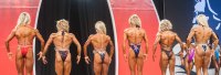 Bikini contestants line up for judges in a female bodybuilding contest