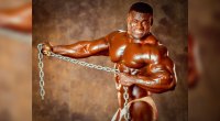 Bodybuilder Victor Richards posing with a metal chain