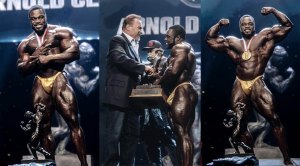 Arnold Schwarzenegger handing 2022 Arnold Classic winner Brandon Curry his trophy copy