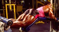 Bodybuilder Lee Haney performing leg curls exercise at the gym
