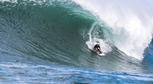 Surfer Koa Smith riding a wave through the pipe