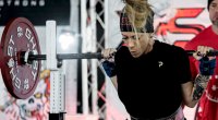 Tanya Corbett lifting a barbell off the rack and preparing for a powerlift competition