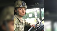 Viktoria Grygorian making a funny face while driving a military truck