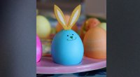 Blue Easter egg with bunny ears and a smiley face