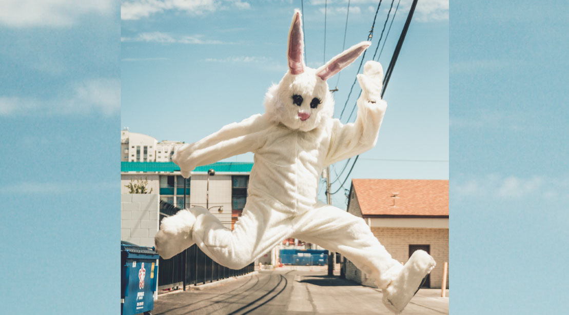 Easter bunny jumping in public street
