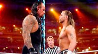 The Undertaker staring down and sizing up wrestler Shawn Michaels