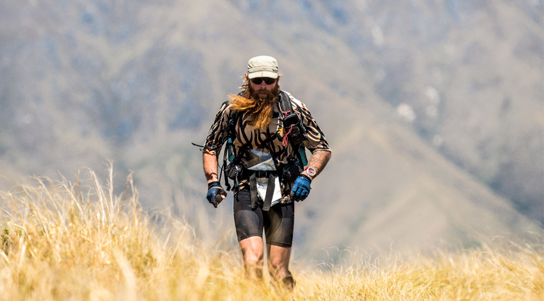 US Navel Seal vet and ultramarathon competitor Chadd Wright racing in a field of tall grass