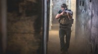 Army Ranger Tim Kennedy aiming for an assault shotgun in an empty hallway
