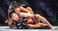 Female MMA fighter and One Atomweight champion Angela Lee grappling with her opponent