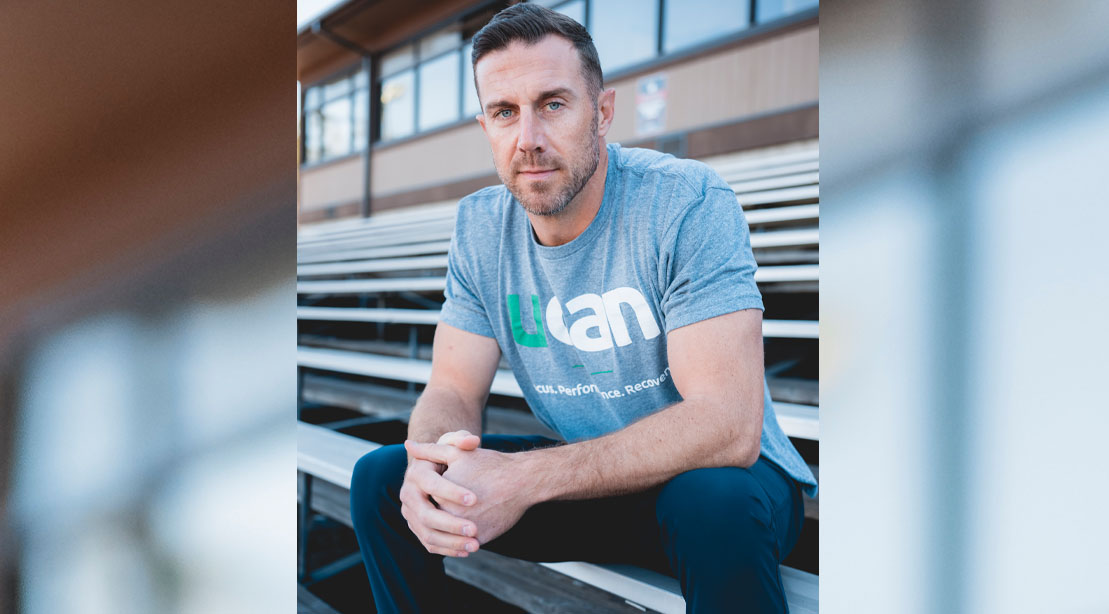 NFL Kansas City Chiefs Quarterback Alex Smith sitting on the bleacher and wearing a UCAN t-shirt
