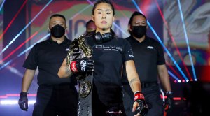 ONE MMA Fighter Angela Lee walking down the ring holding her atomweight championship belt