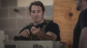 Tim Kennedy showing a male how to take apart a pistol