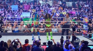 WWE Women's Tag Team Champs Boss and Glow Sasha Banks and Naomi holding their championship belts