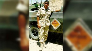Ken Falke helping vets overcome PTSD in army uniform standing next to a truck