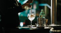Bartender and mixologist make a gin cocktail