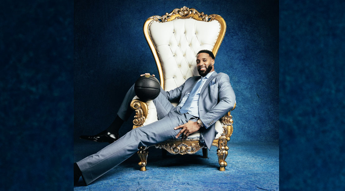 Former NBA hall of famer Tracy McGrady leaning on a throne with a basketball