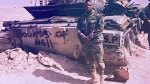Johnnie Jackson in full army gear in front of a Hounds of Hell tank