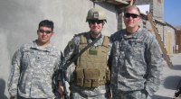 Captain Mike Erwin posing with his friends while being deployed to Iraq
