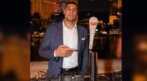 NHL NY Rangers Hockey player Ryan Reaves pointing at a tap of his own beer