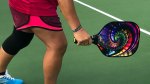 Person playing pickleball and holding a pickleball paddle