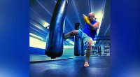 Champion kickboxer Stuart Dansby training and kicking a heavy bag