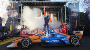 IndyCar Star Scott Dixon Gym celebrating his victor on the race track and standing on top of his race car