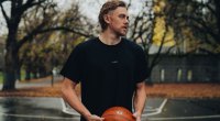 Model playing basketball in a LSKD t-shirt