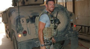 Nate Boyer wearing military gear in front of a humvee
