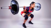 Powerlifting champ Karenjeet Kaur Bains performing a back squat exercise